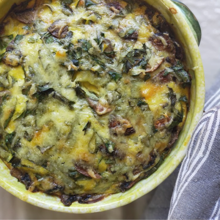 Mushroom and Spinach quiche in the dish with oven mits