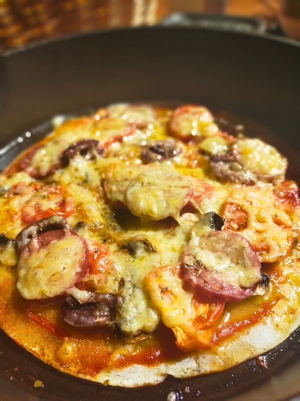 cooked gluten free cast-iron pizza in a skillet