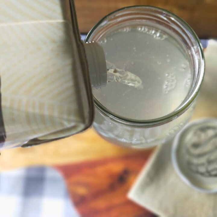 Pouring coconut water kefir into a jar