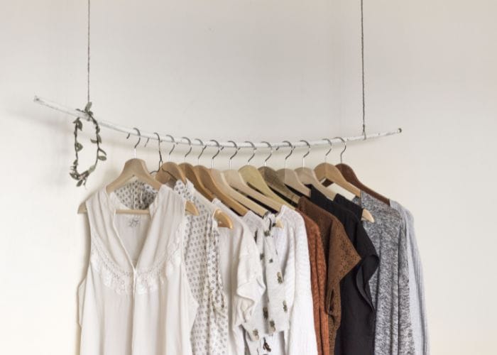 Rail with clothes hangers drying clothes indoors