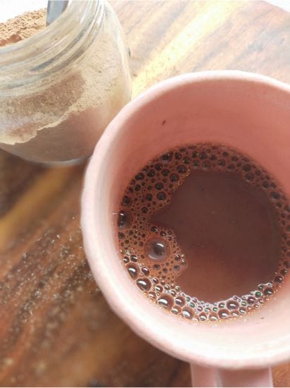 pink mug with hot chocolate and boiling water mixed
