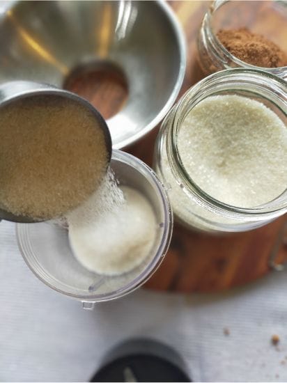 pouring golden sugar into the tumbler ready to mix in the bullet